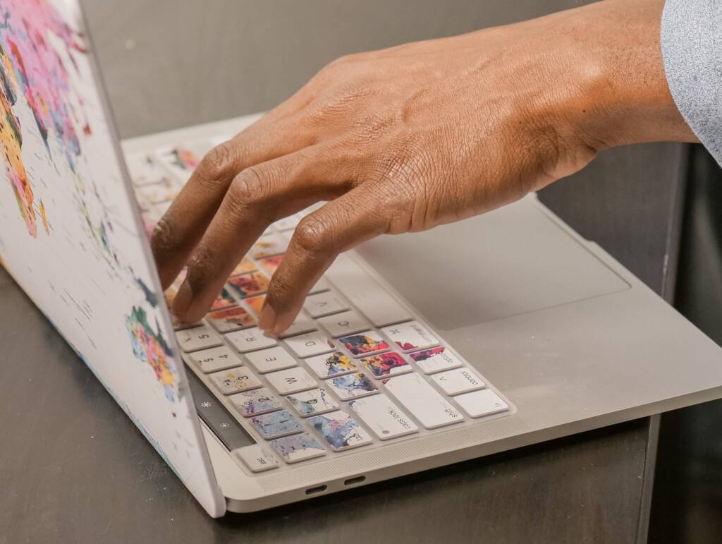 Hand on laptop